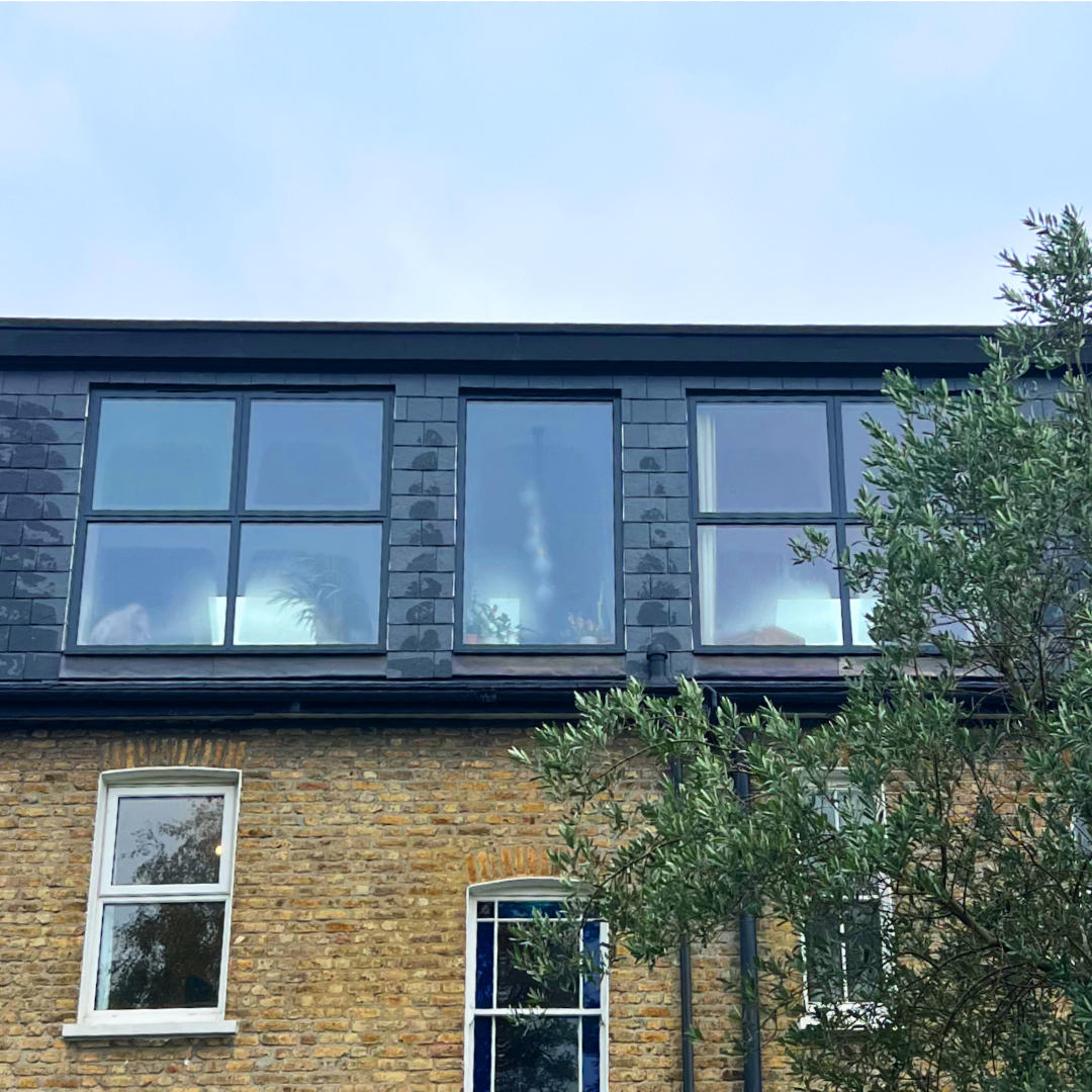 minard-lewisham-loft-conversion-detail-exterior Sleek slate cladding against beautiful London stock brickwork. Our aim is to complement your home's best features, with lofts that flow seamlessly both inside and out.