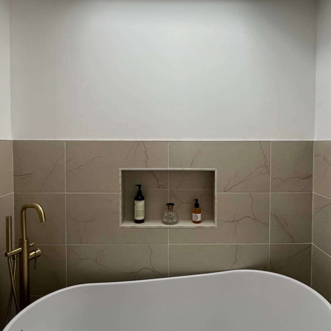 herne-hill-road-detail-bathroom Recessed tiled shelving provides a focal feature above this sleek modern bathtub in a South London loft bathroom.