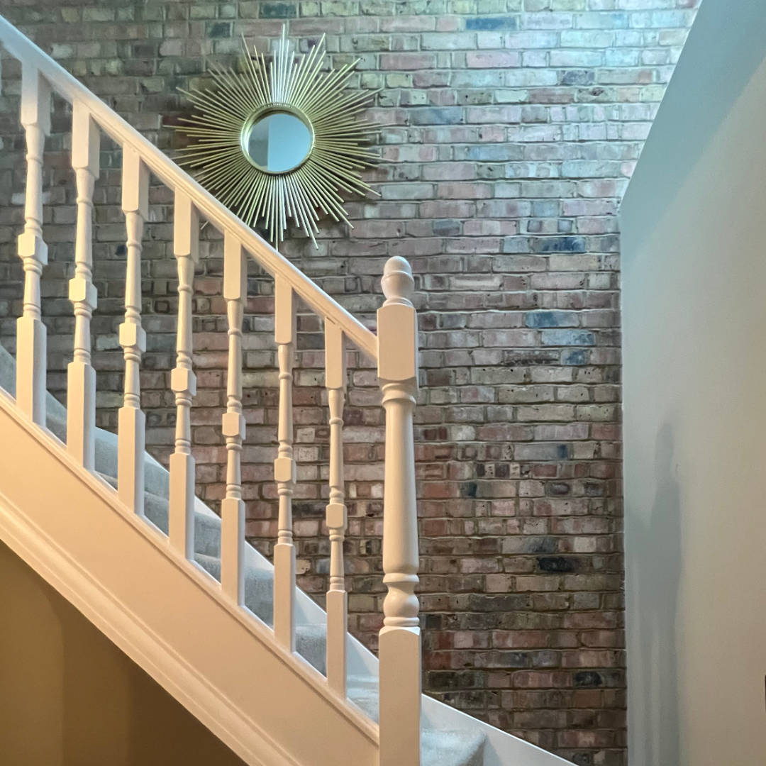 herne-hill-road-detail-staircase White wooden staircase bannisters contrast against a beautiful wall of London stock brickwork in this loft conversion in Herne Hill.